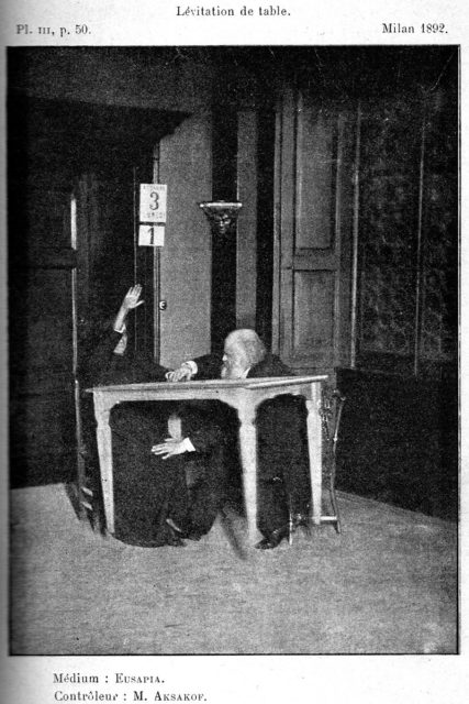 Alexandr Aksakov (right) "controls" while Palladino levitates table, Milan, 1892