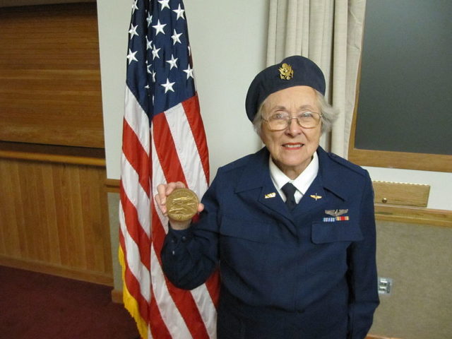 Madge Moore showing the Daedalian Fighter Flight (Nellis AFB, NV) the WASP Congressional Gold Medal she was presented in Washington, D.C.