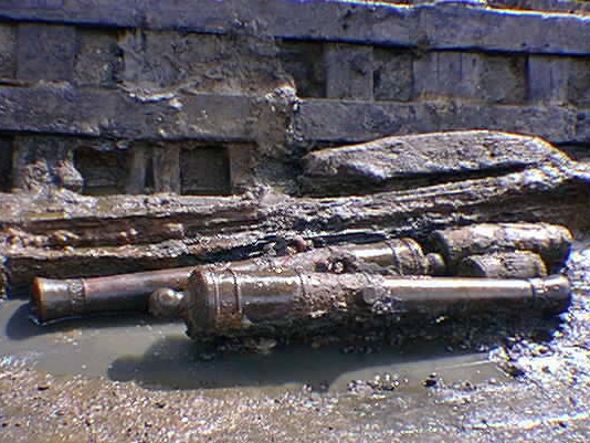 Bronze cannon and other artifacts exposed in the lowermost part of the hull remains as seen during the final stages of excavation in February 1997.