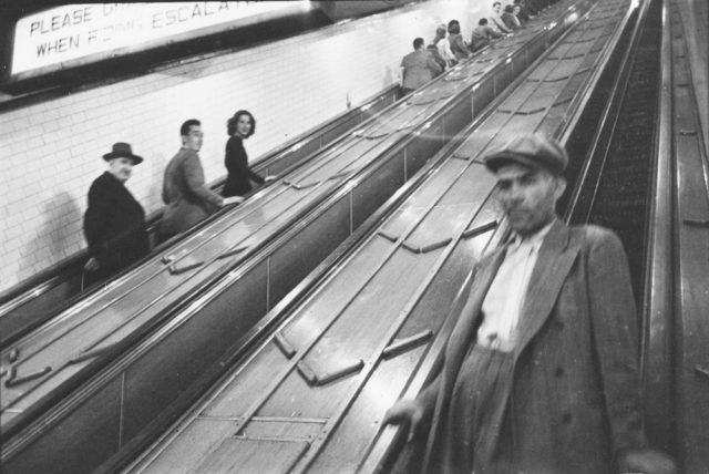 People on escalators in a subway station. 1946 Photo Credit