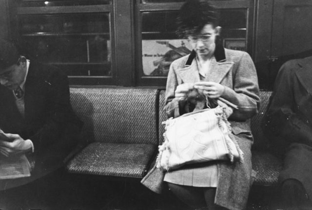 Woman knitting on a subway. 1946 Photo Credit