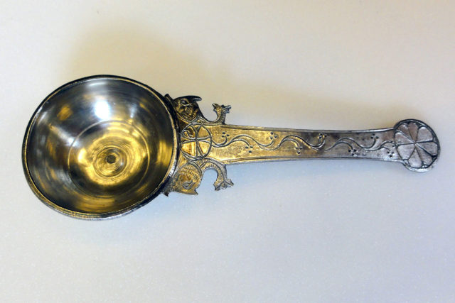 A 13 cm (5.1 in) long ladle from the hoard, with decoration including a Chi-Rho and sea-creatures. Photo Credit