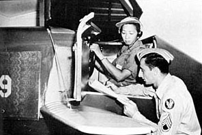 Hazel Ying Lee reviews her performance after a session in a Link trainer. (U.S. Air Force photo)