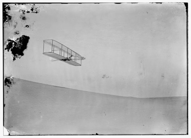 Wilbur gliding down steep slope of Big Kill Devil Hil Photo Credit 