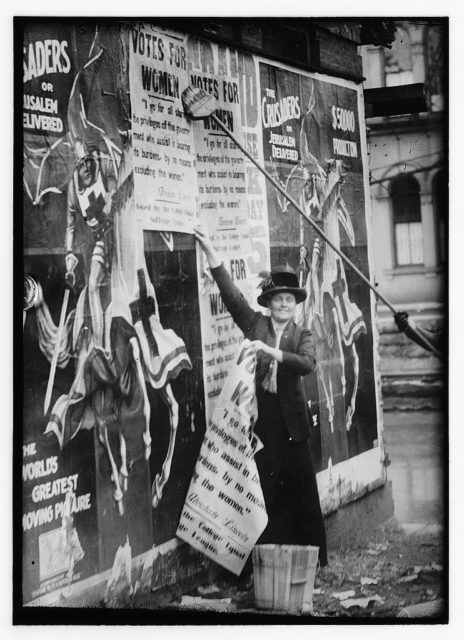 Suffragettes posting bills
