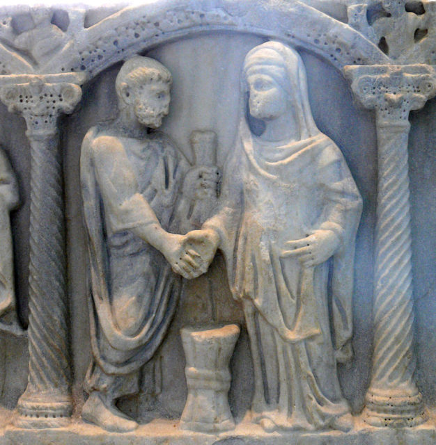 Roman couple joining hands; the bride's belt may show the knot symbolizing that the husband was "belted and bound" to her, which he was to untie in their bed (4th century sarcophagus) Photo Credit