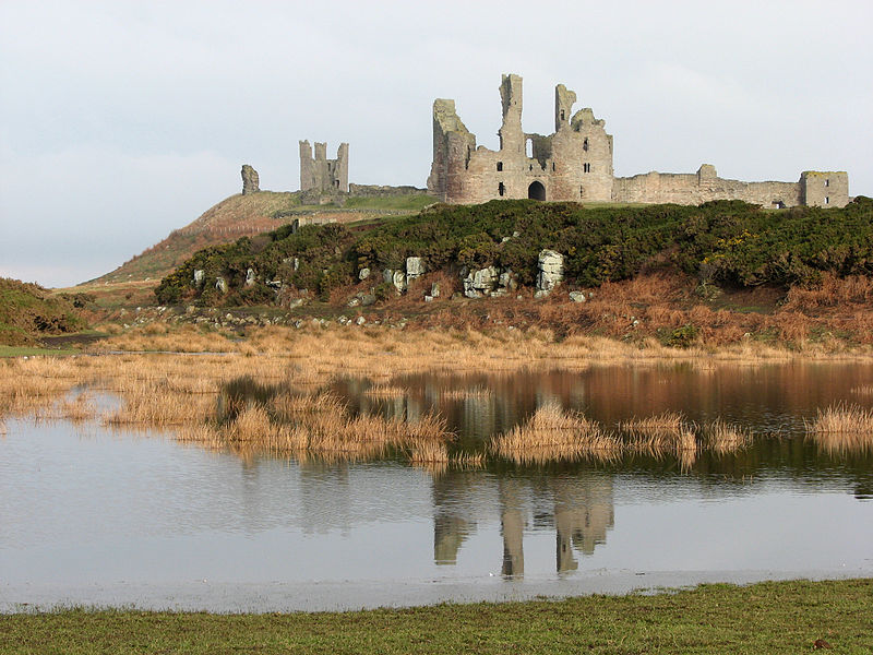 Dunstanburgh Castle, reflected in the remains of the southern mere. Photo Credit