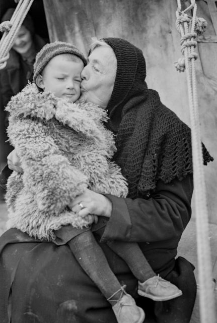 Polish woman kissing her grandaughter Photo Credit