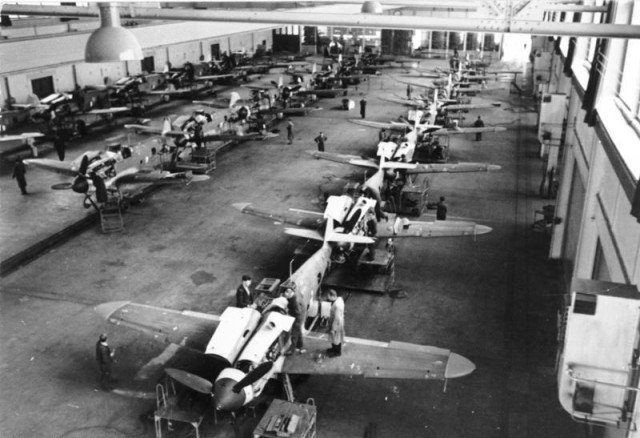 Assembly of Bf 109G-6s in a German aircraft factory. Photo Credit