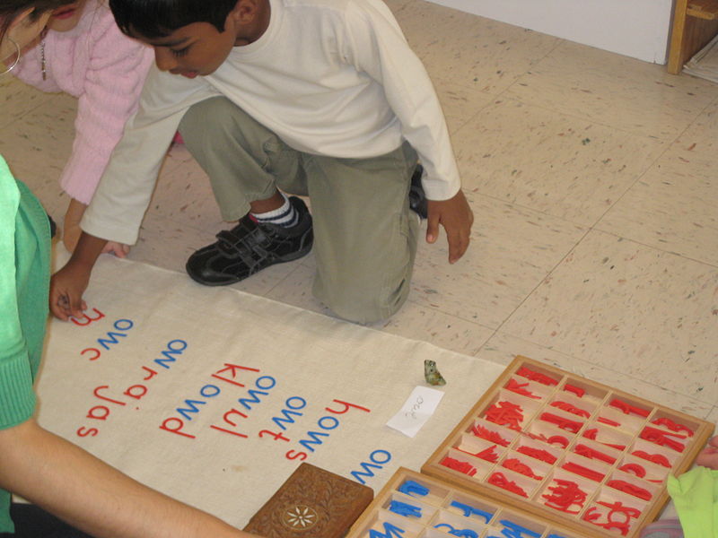 Children working on the phonogram moveable alphabet at a Montessori school