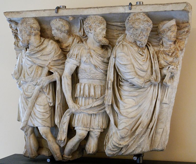 Fragment of a relief from a sarcophagus depicting stages of the deceased’s life: religious initiation, military service, and wedding (mid-2nd century AD). Photo Credit