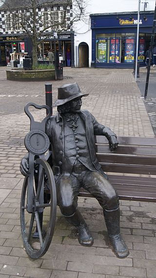 Statue of Blind Jack Metcalf, Market Place, Knaresborough, North Yorkshire. The device in his hand is a Surveyor's wheel. Photo credit