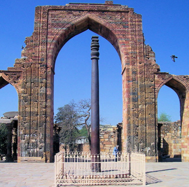 The Iron pillar stands within the courtyard of Quwwat-ul-Islam Mosque Photo Credit