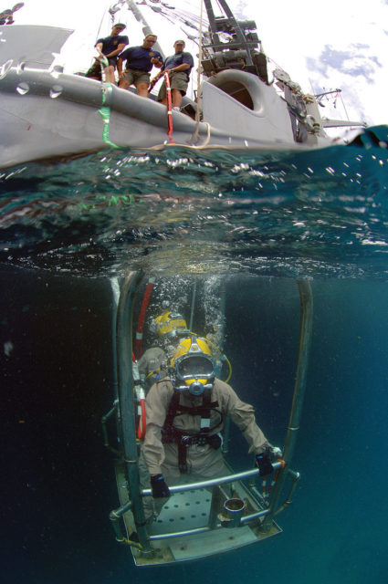 A diver rides a stage to the sea bed from USNS Grasp in St. Kitts during Global Fleet Station 2008.