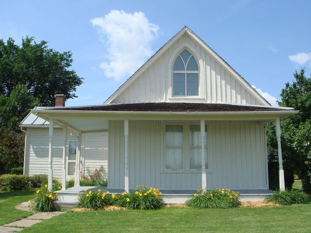 The American Gothic House, also known as the Dibble House, is a house in Eldon, Iowa, designed in the Carpenter Gothic style with a distinctive upper window. It was the backdrop of the 1930 painting ‘American Gothic’ by Grant Wood.