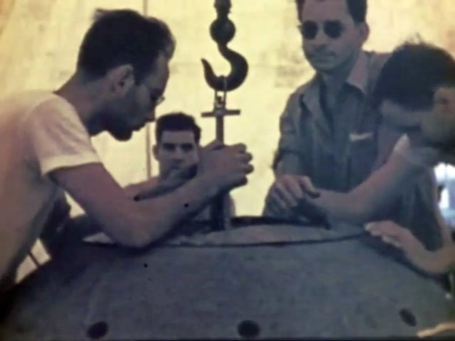 The two physicists Harry Daghlian (center left) and Louis Slotin (center right) during the Trinity Test.