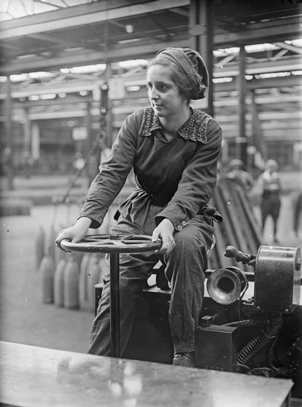 A portrait of a woman war worker as she drives her trolley around the factory floor at Chilwell shell-filling factory in Nottinghamshire