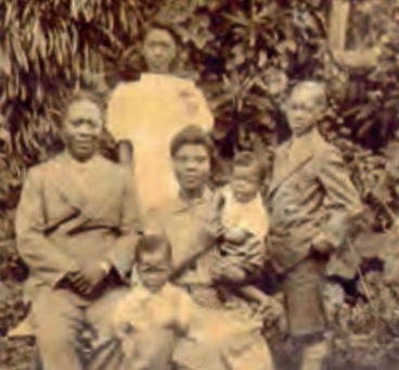 Reverend Israel and Funmilayo beside him, Dolu is at the back and Fela in the foreground, with a baby in arms (unnamed but most likely his brother, Beko), and Olikoye is to the right. Photo Credit