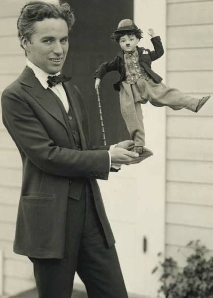 By 1916, Chaplin was a global phenomenon. Here he shows off some of his merchandise, c. 1918