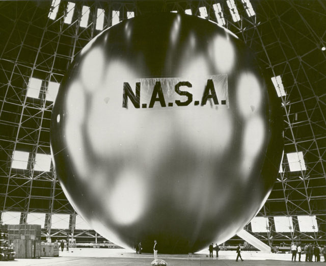 The 135-foot rigidized inflatable balloon satellite is undergoing a tensile stress test in a dirigible hanger at Weekesville, North Carolina. The Echo II was 50 times more rigidized than Echo