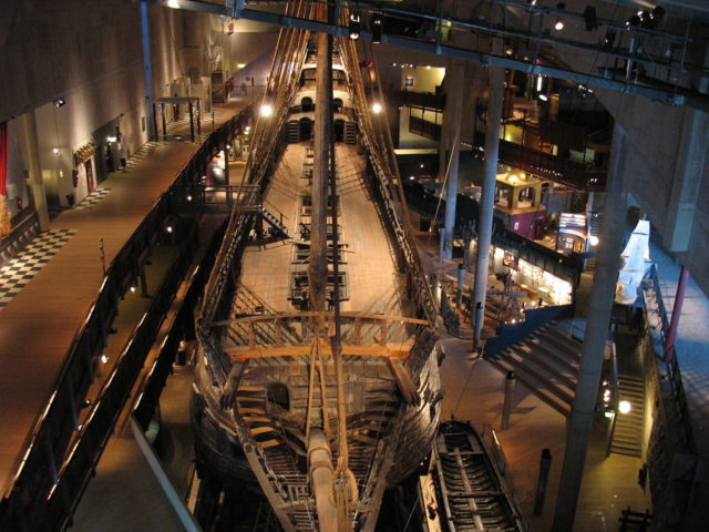 The preserved Vasa in the main hall of Vasa Museum seen from above the bow. Source