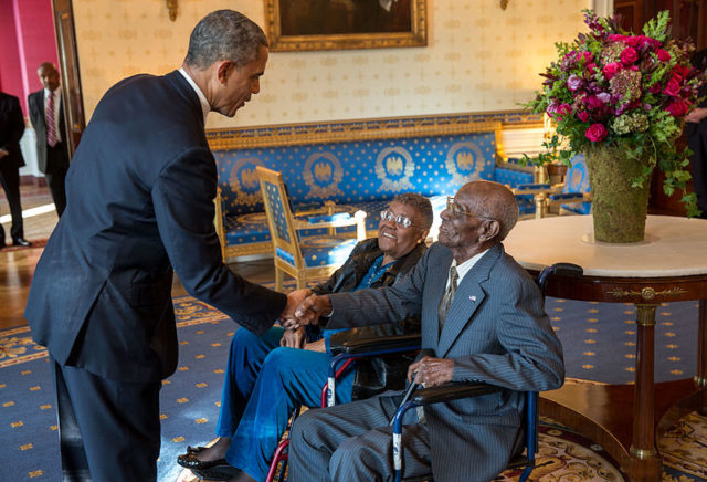 U.S. President Barack Obama shakes hands with Overton at the White House on Veterans Day 2013