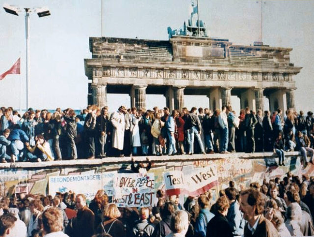 The Berlin Wall in front of the Brandenburg Gate, shortly before its fall in 1989, photo credit
