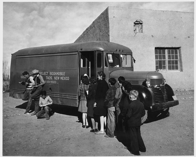 Taos County, New Mexico. Children line up for books when Taos County project bookmobile visits school at Prado (1941)