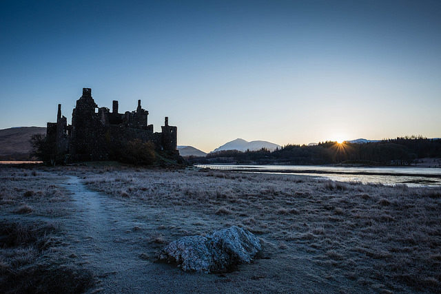 An astounding view of Kilchurn Castle standing alone on the long peninsula and surrounded by the wilderness.Photo Credit