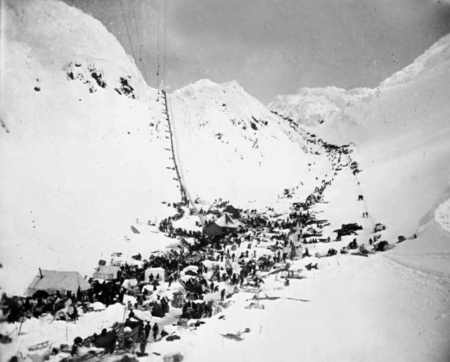 Prospectors with supplies at the Chilkoot Pass. In front: The Scales, left: Golden Steps. c. March 1898