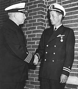 Lt. John F. Kennedy, USNR, is awarded the Navy and Marine Corps Medal for “…extremely heroic conduct as Commanding Officer of Motor Torpedo Boat 109…”