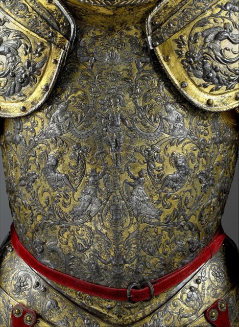 The center of the breastplate is decorated with a figure of a Roman warrior receiving a tribute of arms from a pair of kneeling ladies. Photo Credit