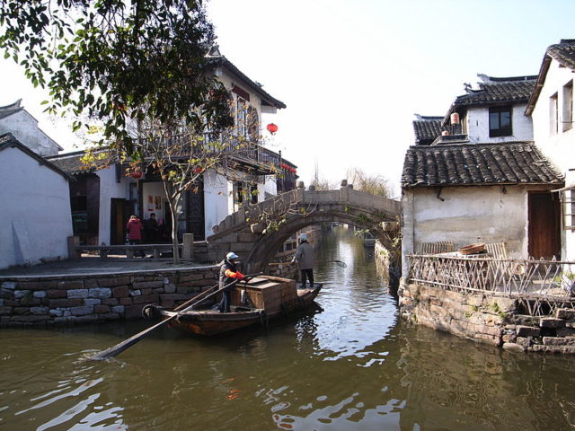 Boat in Zhouzhuang passing through canals. Photo Credit