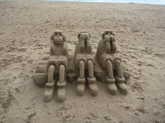 Three wise monkeys on the beach in Barcelona Photo Credit