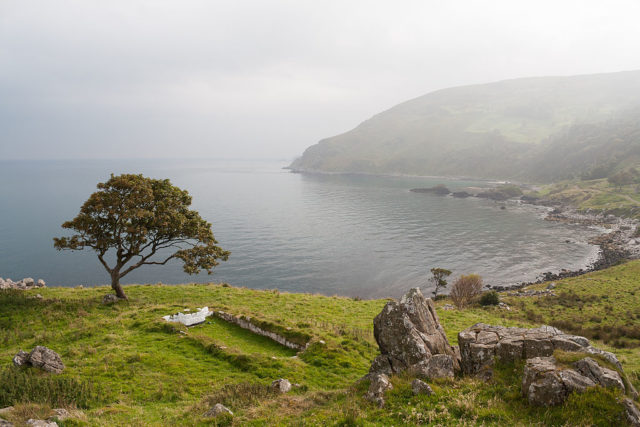 Surviving ruins of Drumnakill Church in the townland of Bighouse, located close to a group of rocks at Murlough Bay. Photo Credit