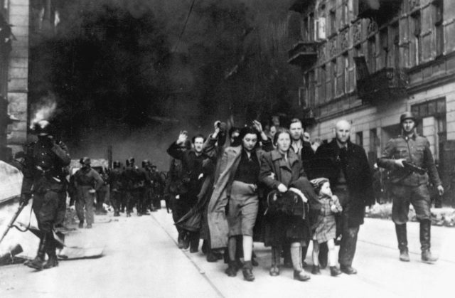 Captured Jews are led by German troops to the assembly point for deportation. Picture taken at Nowolipie street, near the intersection with Smocza