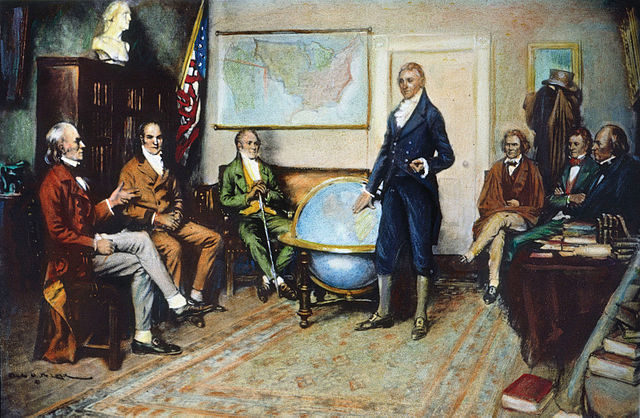 U.S. President James Monroe, standing, presides over a cabinet meeting in 1823, with then-Secretary of War John C Calhoun notable in the background