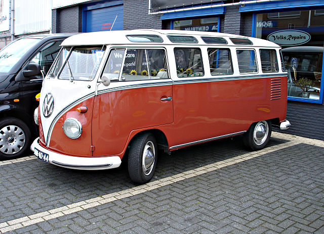 A red Volkswagen Samba bus featuring 21 windows including eight panoramic windows in the roof. Author Voogd075, CC BY-SA 3.0