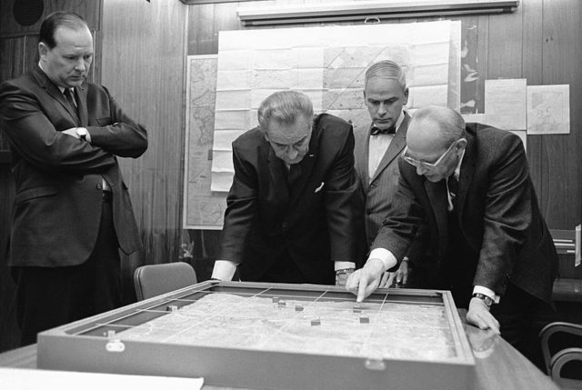 Situation Room: National Security Advisor Walt Rostow showing President Lyndon B. Johnson a model of the Khe Sanh area on February 15, 1968.