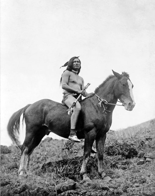 The old-time warrior: Nez Percé, c. 1910. Nez Percé wearing loin cloth and moccasins on horseback.