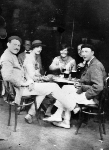 Hemingway (left), with Harold Loeb, Duff Twysden (in hat), Hadley Hemingway (his first wife), Donald Ogden Stewart (obscured), and Pat Guthrie (far right) at a café in Pamplona, Spain, July 1925. Twysden, Loeb, and Guthrie inspired the characters Brett Ashley, Robert Cohn, and Mike Campbell in “The Sun Also Rises.”