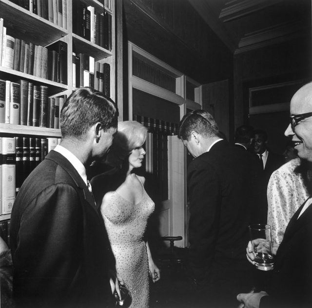 U.S. President John F. Kennedy (with his back to the camera), U.S. Attorney General Robert Kennedy (far left), and actress Marilyn Monroe, on the occasion of President Kennedy’s 45th birthday celebrations at Madison Square Garden in New York City. Arthur M. Schlesinger is at the far right. Facing the camera in the rear is singer Harry Belafonte.