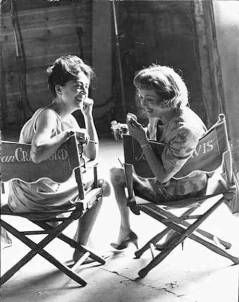 Joan Crawford and Bette Davis smile for the press photographers on the set of “What Ever Happened to Baby Jane?” Photo by Erasmo de Havilland, CC BY-SA 4.0