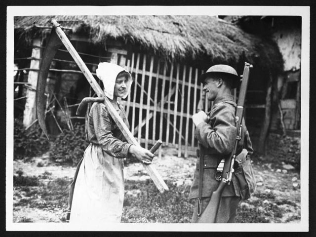 A British soldier talks to a local farm worker.