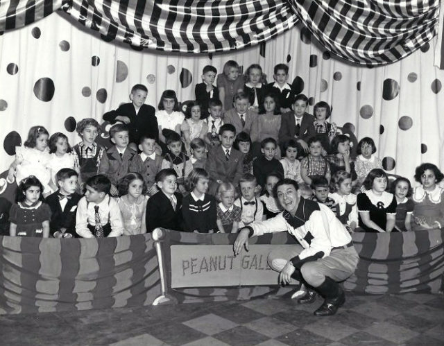 Photo of host Buffalo Bob Smith and the live children’s audience from the television program Howdy Doody. The show’s name for where the children were seated during the broadcast was “The Peanut Gallery.”