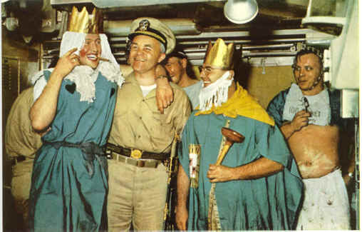 Crossing the equator ceremony, with “Davy Jones” wearing a yellow cape and a plunger as a scepter. The ceremony above took place aboard the USS Triton, 24 February 1960 as part of the Operation Sandblast cruise.