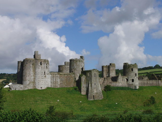The east side of Kidwelly Castle as seen from a nearby hill Author:Iphrit CC BY-SA 3.0