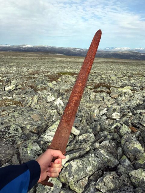 The finder holding the sword, just moments after it was discovered. Photo: Einar Åmbakk.