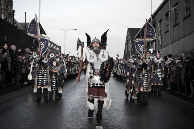 “Shetland Isles, North of Scotland, UK – January, 29th 2013: The Guizer Jarl (chief viking) leading his squad of viking men and children through the streets of Lerwick in the Shetland Isles. As the thousands of spectators look on in admiration of the attire they have spent the last 12 months crafting by hand.”