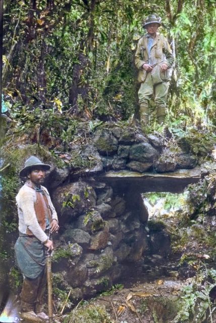 Hiram Bingham III standing atop a jungle bridge at Espiritu Pampa
